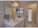 Bathroom featuring white cabinets and a mirror reflecting the shower with patterned curtain at 12805 Raysbrook Dr, Riverview, FL 33569