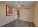 Bedroom featuring wood floors, ceiling fan, and decor hanging on the walls at 12805 Raysbrook Dr, Riverview, FL 33569