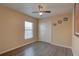 Bedroom with wood floors, a ceiling fan, a window, and a closet at 12805 Raysbrook Dr, Riverview, FL 33569