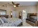 Comfortable bedroom with a ceiling fan, shuttered windows, and a neutral color palette at 12805 Raysbrook Dr, Riverview, FL 33569