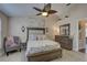 Comfortable bedroom with a ceiling fan, shuttered windows, and a neutral color palette at 12805 Raysbrook Dr, Riverview, FL 33569