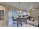 Cozy dining area boasts sliding glass doors, ceiling fan and comfortable seating at 12805 Raysbrook Dr, Riverview, FL 33569