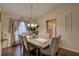 Elegant dining room with a modern chandelier, neutral decor, and ample natural light at 12805 Raysbrook Dr, Riverview, FL 33569