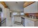 Bright kitchen features white cabinets, stainless steel appliances, and tile flooring at 12805 Raysbrook Dr, Riverview, FL 33569