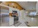 Bright kitchen features white cabinets, stainless steel appliances, and tile flooring at 12805 Raysbrook Dr, Riverview, FL 33569