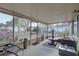 Enclosed lanai is furnished with comfortable seating and views of the backyard at 12805 Raysbrook Dr, Riverview, FL 33569