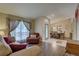 Cozy living room with hardwood floors, large window, comfortable seating, and dining area at 12805 Raysbrook Dr, Riverview, FL 33569
