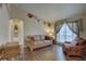 Comfortable living room with hardwood floors, large window, and decorative accents at 12805 Raysbrook Dr, Riverview, FL 33569