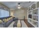 Inviting living room featuring vaulted ceiling, custom shelving and plush gray sofa with yellow pillows at 12805 Raysbrook Dr, Riverview, FL 33569