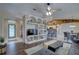 Spacious living room with custom built-in shelving, ceiling fan and hardwood floors at 12805 Raysbrook Dr, Riverview, FL 33569