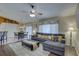 Comfortable living room features a plush gray sofa, ceiling fan and lots of natural light at 12805 Raysbrook Dr, Riverview, FL 33569