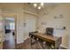 Office featuring a ceiling fan, desk, wood floors, and decor hanging on the walls at 12805 Raysbrook Dr, Riverview, FL 33569