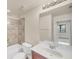Bathroom featuring neutral tile, wooden cabinets, a tub, and a shower at 1349 Aqui Esta Dr # 143, Punta Gorda, FL 33950