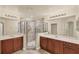 Bathroom showcasing dual vanities, a glass shower, and modern lighting fixtures at 1349 Aqui Esta Dr # 143, Punta Gorda, FL 33950