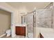 Bathroom featuring granite counters, dark wood cabinetry, and a glass-enclosed shower at 1349 Aqui Esta Dr # 143, Punta Gorda, FL 33950
