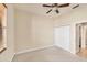 An empty bedroom with a window, carpeted floor, a ceiling fan, and a closet at 1349 Aqui Esta Dr # 143, Punta Gorda, FL 33950