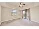 Bedroom featuring a ceiling fan, large window, and slider door leading to the balcony at 1349 Aqui Esta Dr # 143, Punta Gorda, FL 33950