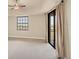 Bedroom with carpet, slider to balcony, and large window for ample natural light at 1349 Aqui Esta Dr # 143, Punta Gorda, FL 33950