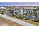 Stunning exterior view of a multi-story building with meticulous landscaping and architectural details at 1349 Aqui Esta Dr # 143, Punta Gorda, FL 33950
