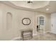 Inviting foyer with tile flooring, modern mirror, and a view into adjacent room at 1349 Aqui Esta Dr # 143, Punta Gorda, FL 33950