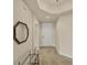 Inviting foyer with tile flooring, modern mirror, and a view into adjacent room at 1349 Aqui Esta Dr # 143, Punta Gorda, FL 33950