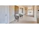 Hallway with neutral walls, sconces, and view of sitting area; entrance door is visible at 1349 Aqui Esta Dr # 143, Punta Gorda, FL 33950