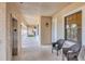 Well-lit hallway featuring neutral tones, a window with natural light, and seating area near elevator at 1349 Aqui Esta Dr # 143, Punta Gorda, FL 33950