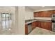 Open concept kitchen with tile floors, wood cabinets and stainless steel appliances at 1349 Aqui Esta Dr # 143, Punta Gorda, FL 33950