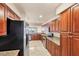 Kitchen with stainless steel appliances, granite counters and wood cabinets at 1349 Aqui Esta Dr # 143, Punta Gorda, FL 33950