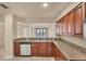 Kitchen with stainless steel appliances and granite counters overlooks the living area and balcony at 1349 Aqui Esta Dr # 143, Punta Gorda, FL 33950