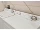 Laundry room featuring a standard top loading washing machine and dryer at 1349 Aqui Esta Dr # 143, Punta Gorda, FL 33950