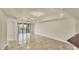 Open living room with tile flooring and an expansive balcony offering outdoor views at 1349 Aqui Esta Dr # 143, Punta Gorda, FL 33950