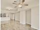 Open floor plan with neutral walls, tile flooring, and a ceiling fan at 1349 Aqui Esta Dr # 143, Punta Gorda, FL 33950