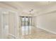 Bright and airy living room featuring neutral tones, tile floors, and access to a balcony at 1349 Aqui Esta Dr # 143, Punta Gorda, FL 33950