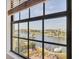 Water view through a large window with an amazing landscape, docks, and a boat at 1349 Aqui Esta Dr # 143, Punta Gorda, FL 33950