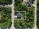 Aerial view of a secluded home surrounded by lush greenery offering privacy and tranquility at 14009 Daniels Ave, Port Charlotte, FL 33953