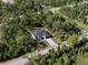 Aerial view showing a modern home set among trees in a quiet neighborhood, creating a peaceful and private ambiance at 14009 Daniels Ave, Port Charlotte, FL 33953