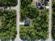 Bird's eye view of a modern home in a lush area, showcasing its surroundings and property layout at 14009 Daniels Ave, Port Charlotte, FL 33953