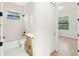 Modern bathroom with white tiled walls, soaking tub, and stylish vanity at 14009 Daniels Ave, Port Charlotte, FL 33953