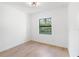 Well-lit bedroom featuring hardwood floors and a large window with nature view at 14009 Daniels Ave, Port Charlotte, FL 33953