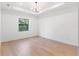 Bright, airy bedroom with hardwood floors, recessed lighting, and large window at 14009 Daniels Ave, Port Charlotte, FL 33953