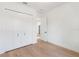 Modern bedroom featuring hardwood floors and spacious closet doors at 14009 Daniels Ave, Port Charlotte, FL 33953