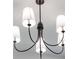 Elegant chandelier featuring white lampshades and a black metal frame, adding a touch of sophistication to any room at 14009 Daniels Ave, Port Charlotte, FL 33953