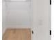 A bright closet featuring wire shelving, hardwood floors, and white trim at 14009 Daniels Ave, Port Charlotte, FL 33953