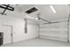 Spacious two-car garage featuring epoxy flooring, overhead lighting, and white walls at 14009 Daniels Ave, Port Charlotte, FL 33953