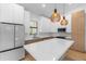 Bright kitchen with island, modern appliances, and pendant lighting at 14009 Daniels Ave, Port Charlotte, FL 33953