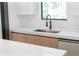 Bright kitchen with stainless steel sink, modern faucet and view from the window at 14009 Daniels Ave, Port Charlotte, FL 33953