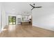 Bright living room with hardwood floors, modern lighting, and access to the backyard at 14009 Daniels Ave, Port Charlotte, FL 33953