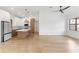 Open-concept living room with hardwood floors, modern ceiling fan, and recessed lighting at 14009 Daniels Ave, Port Charlotte, FL 33953
