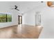 Spacious living room with hardwood floors, modern ceiling fan, and natural light at 14009 Daniels Ave, Port Charlotte, FL 33953